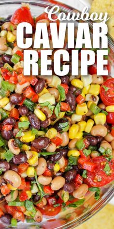 a glass bowl filled with black eyed peas and corn next to tortilla chips