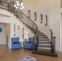 a living room filled with furniture and a stair case