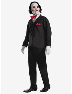 a man in a black suit and red bow tie wearing a creepy mask with his hands on his hips