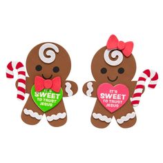 two gingerbreads are holding candy canes and heart shaped paper cutouts with the words sweet to touch jesus written on them