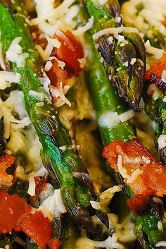 asparagus, tomatoes and cheese on top of pasta