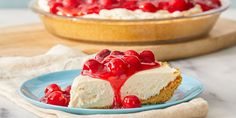 a piece of cheesecake with cherries on top is sitting on a blue plate