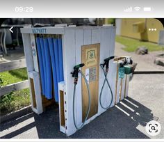 an old gas station with two pumps and hoses attached to the side of it