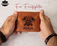 a hand holding a wallet with the words for firefighter on it