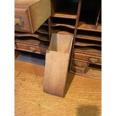 a wooden desk with drawers and other furniture