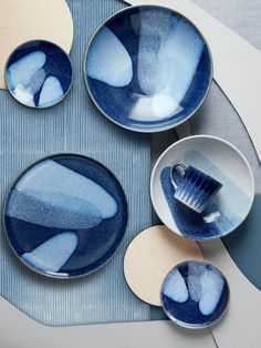 blue and white dishes are arranged on a table