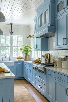 a kitchen with blue cabinets and white counter tops