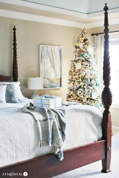 a bedroom decorated for christmas with a tree in the corner