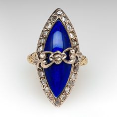 This beautiful mid-Victorian ring is centered with one (1) rose cut diamond bead set into a sterling silver setting set against navette shaped blue enamel dome and encircled with twenty-four (24) rose cut diamonds bead set into sterling silver settings. The under-gallery and the engraved shaped are constructed of 18K yellow gold. The ring measures 27.0mm at the top, rises 10.0mm above the finger, tapering to 2.6mm wide and 1.0mm thick at the base of the shank. This ring is currently a size 2.75. 1 Rose, Silver Tops, Victorian Rings, 18k Yellow Gold Ring, Rose Cut Diamond, High Quality Jewelry, Rose Cut, Estate Jewelry, Sterling Ring