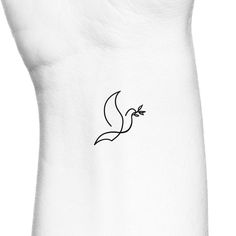 a small black bird tattoo on the back of a woman's left upper arm