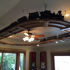 the ceiling fan is hanging from the rafters