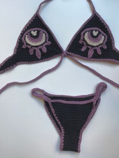 three crocheted bikinisuits with eyeballs on them