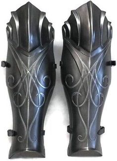 pair of black leather knee pads with intricate design