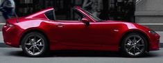 a red sports car parked in front of a building