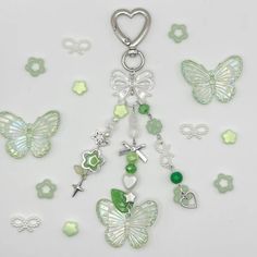 a key chain with charms and butterflies on it