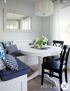 a white table and chairs in a room