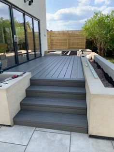 an outdoor deck with steps leading up to it