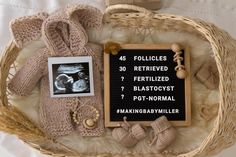 a basket filled with baby items and a sign that reads, follicles fertited fertitized blasatocyst post - normal