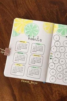 a notebook with a calendar on it and a chain attached to the cover that says habitts