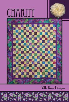 a purple and green quilt with the words charity written in black on it, along with an image of a flower