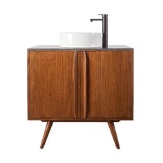 a bathroom sink sitting on top of a wooden cabinet next to a faucet