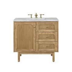 a bathroom vanity with two faucets on the top and one sink below it