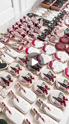 a table topped with lots of decorated cookies