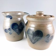 two ceramic pitchers with hearts painted on them