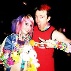 the man and woman are dressed up in costumes for a halloween costume party with candy on their hands