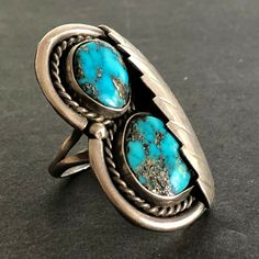 "VINTAGE NAVAJO RING DESCRIPTION: Two breathtaking specimens of high blue Morenci turquoise, this ring will be a treasured addition to your collection of fine vintage Native American jewelry. MEASUREMENTS: Ring face measures 1 5/8\" x 1\" RING SIZE: 7 1/4 WEIGHT: 14.9 grams SIGNED: no STERLING: unmarked, verified sterling silver" Antique Turquoise Anniversary Ring, Southwestern Blue Open Ring Jewelry, Antique Untreated Turquoise Jewelry, Southwestern Style Blue Open Ring Jewelry, Southwestern Blue Rings For Anniversary, Collectible Round Turquoise Ring, Antique Blue Turquoise Ring For Anniversary, Collectible Blue Turquoise Inlay Ring, Vintage Blue Cabochon Ring