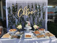 a table topped with lots of food next to a sign that says cloe on it