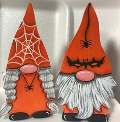 two orange and white gnomes sitting next to each other