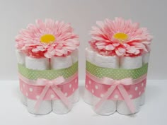 two rolls of toilet paper with pink flowers on them and polka dots around the edges