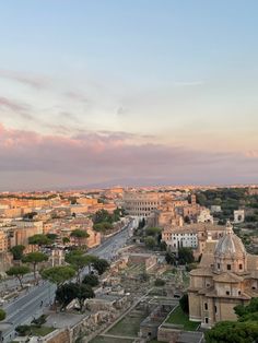 an aerial view of the ancient city of rome, italy at sunset or dawn with pink clouds in the sky