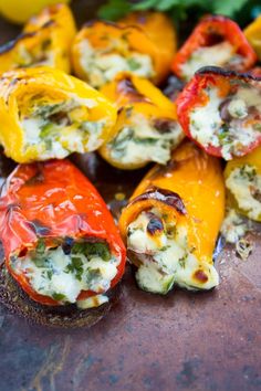 stuffed peppers with cheese and herbs on a cutting board