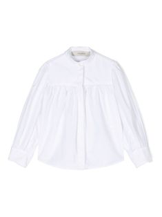 white cotton poplin texture concealed front button fastening band collar gathered detailing long sleeves buttoned cuffs curved hem White Blouse With Elastic Sleeves For Fall, Fall White Blouse With Elastic Sleeves, White Puff Sleeve Blouse With Button Cuffs, Cotton Button-up Blouse With Smocked Cuffs, Cotton Shirt With Gathered Long Sleeves, White Cotton Blouse With Button Cuffs, White Long Sleeve Blouse With Pleated Sleeves, White Long Sleeve Blouse With Smocked Cuffs, Classic White Blouse With Gathered Sleeves