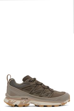 Low-top SensiFit™ grained leather, mesh, and suede sneakers in brown. · Reflective trim bonded throughout · Lace-up closure · Padded tongue and collar · Logo embossed at outer side · Webbing pull-loop at heel tab · Jersey lining · Molded OrthoLite® footbed · Agile Chassis™ System rubber midsole · Treaded Contagrip® rubber outsole Supplier color: Bungee cord/Wren/Almond milk Solomon Xt6, Solomon Shoes, Solomons Shoes, Salomon Boots, Bungee Cord, Suede Sneakers, Almond Milk, Men's Casual, Luxury Streetwear