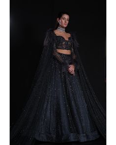 Charcoal Blue Lehenga Set - Bora Honey's Immerse yourself in the allure of our Charcoal Blue Lehenga, a mesmerizing ensemble adorned with an exquisite interplay of stones, crystals, and sequins. The meticulous craftsmanship showcases the intricate detailing of Japanese cut-dana, adding a touch of sophistication and elegance. The ethereal design is further accentuated by delicately incorporated feathers, creating a harmonious blend of tradition and contemporary style in this captivating charcoal Elegant Floor-length Evening Choli, Evening Sets With Sheer Dupatta, Elegant Embellished Sets For Gala, Elegant Festive Set For Gala, Hand Embellished Evening Sets In Floor-length, Elegant Evening Sets With Sheer Dupatta, Hand Embellished Floor-length Evening Sets, Glamorous Blue Sets For Reception, Elegant Blue Choli For Evening