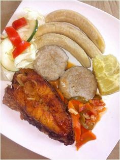 a white plate topped with meat and veggies