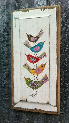 a wooden frame with birds painted on it