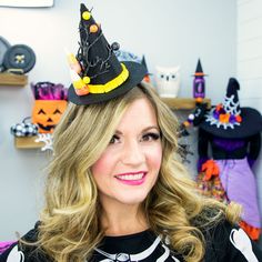 a woman wearing a black hat with a skeleton on it's head and smiling