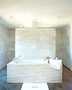 a white bath tub sitting inside of a bathroom