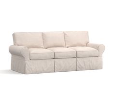 a white couch sitting on top of a white floor