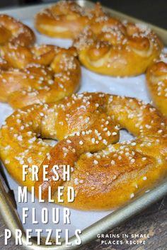 fresh milled flour pretzels on a baking sheet with the words, fresh milled flour pretzels