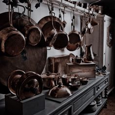 pots and pans are hanging on the wall in an old - fashioned kitchen area