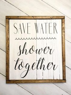 a wooden sign that says save water shower together on the side of a white wall