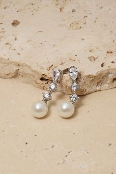 Indulge in timeless elegance with these crystal stud earrings with a delicate pearl drop on the end. Their subtle yet stunning design makes them a must-have accessory for any bride. Wedding Day Earrings, Untamed Petals, Tulle Bodice, Pearl Veil, Bridal Earring, Veil Headpiece, Pleated Tulle, Organza Skirt, Girl Vibe