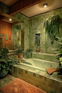 a green tiled bathroom with plants in the tub