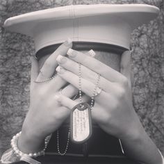 a woman's hands covering the top of her hat