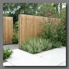 two wooden gates in the middle of a garden